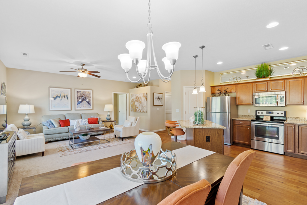 a living room with a dining room table and a kitchen