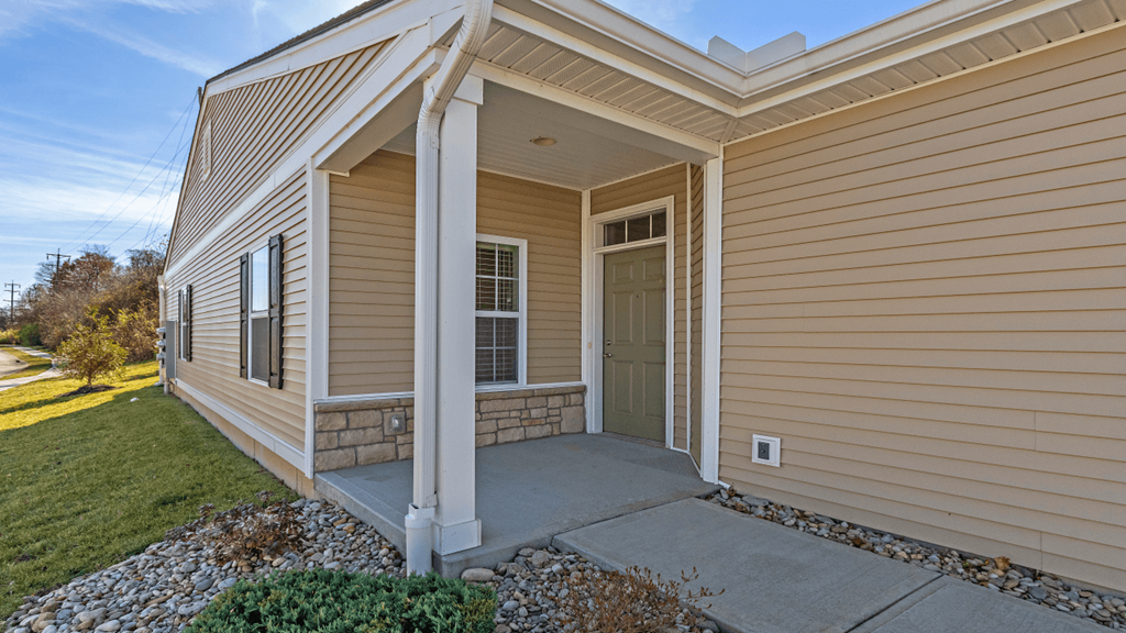 the front door of a house with a porch
