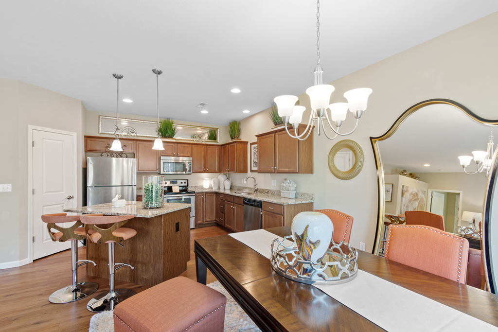 a kitchen and dining room with a table and chairs