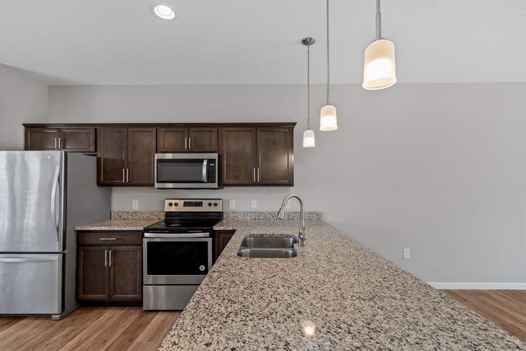 a kitchen with granite counter tops and stainless steel appliances