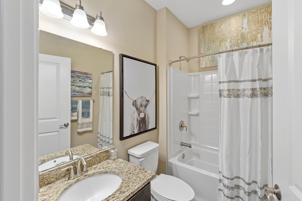 a bathroom with a shower and a sink and a toilet