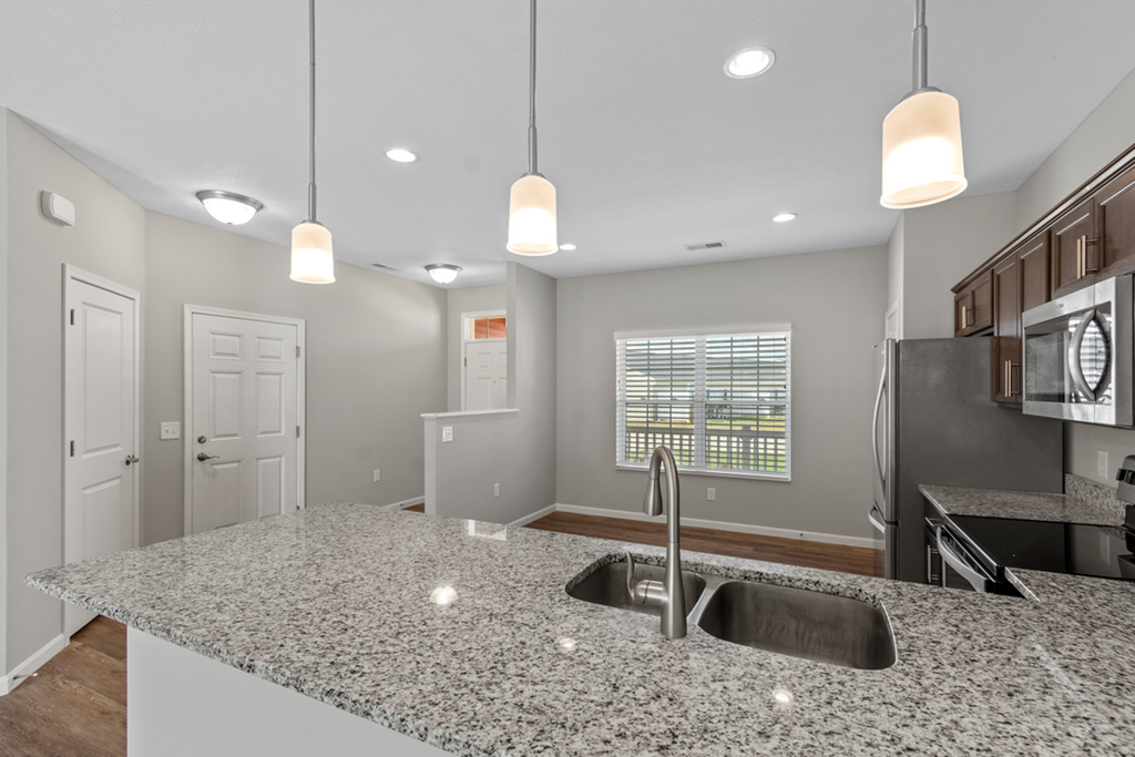 a kitchen with a granite counter top and a sink