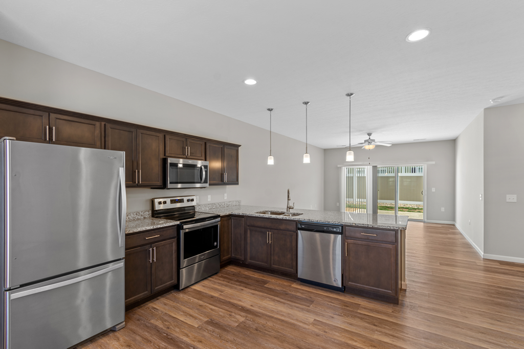 a kitchen with stainless steel appliances and wooden cabinets