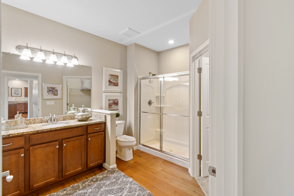 a bathroom with a shower and a sink and a toilet