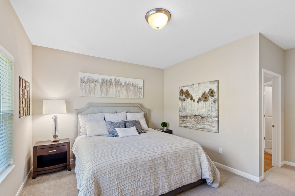 a bedroom with a large bed and a window