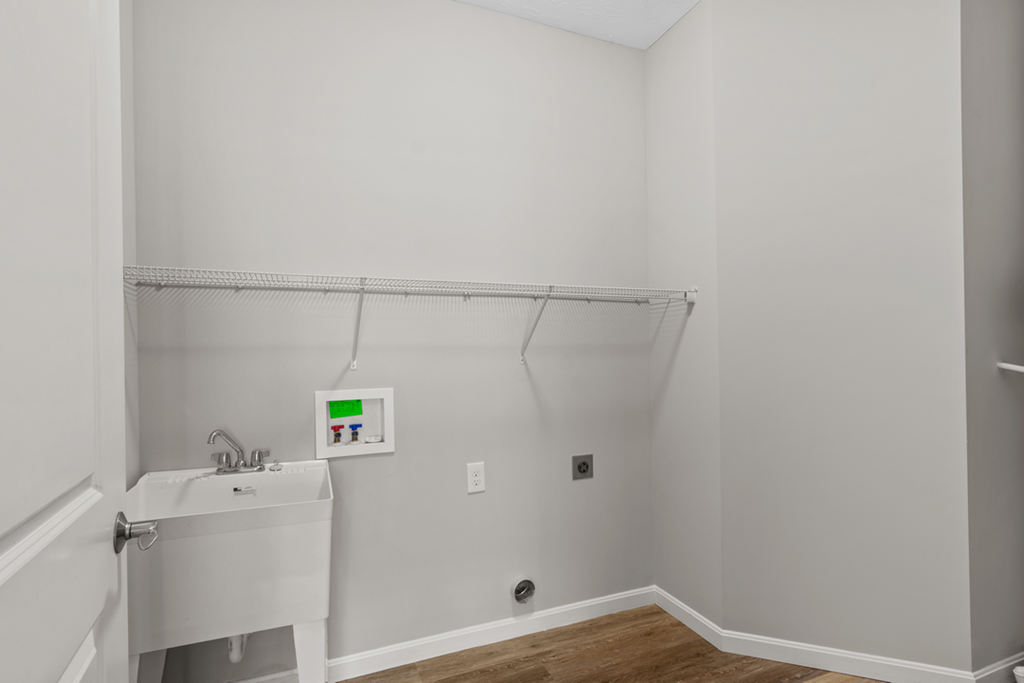 a white bathroom with a sink and a mirror and a shower