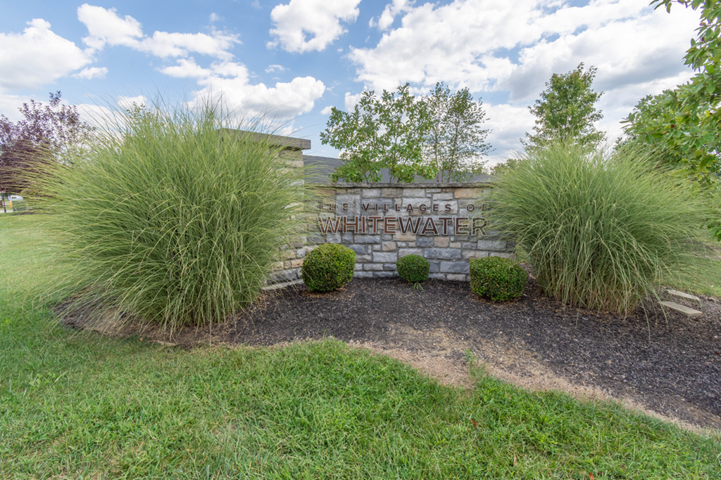 A sign that says Villages of LifeWater is surrounded by grass and plants.