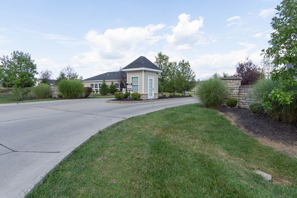 A house with a white fence and a green lawn.
