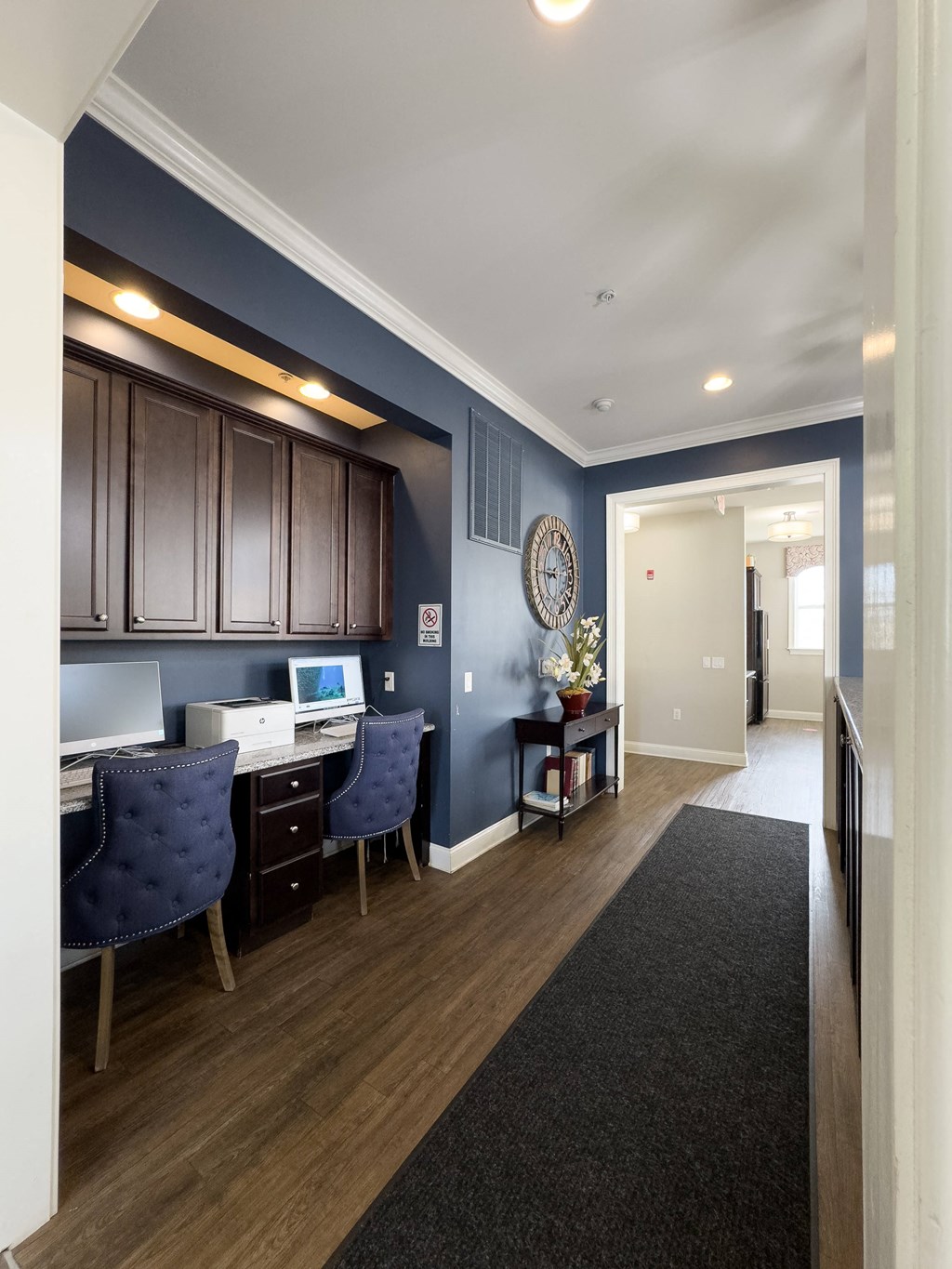 Stylish business center at Queens Gate Apartments featuring modern workstations, comfortable seating, and a sleek design—perfect for remote work and productivity