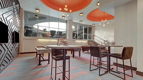 A dining room with a table and chairs.