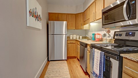 A kitchen with a white refrigerator and a stove top oven.