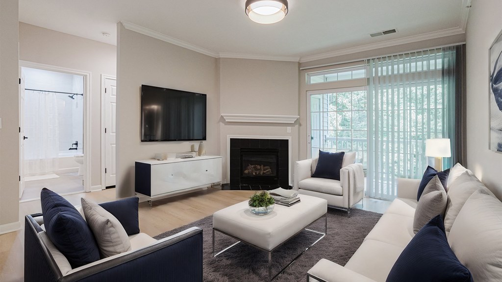 a living room with a couch and a chair and a fireplace