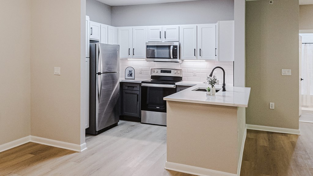 a kitchen with stainless steel appliances and white cabinets