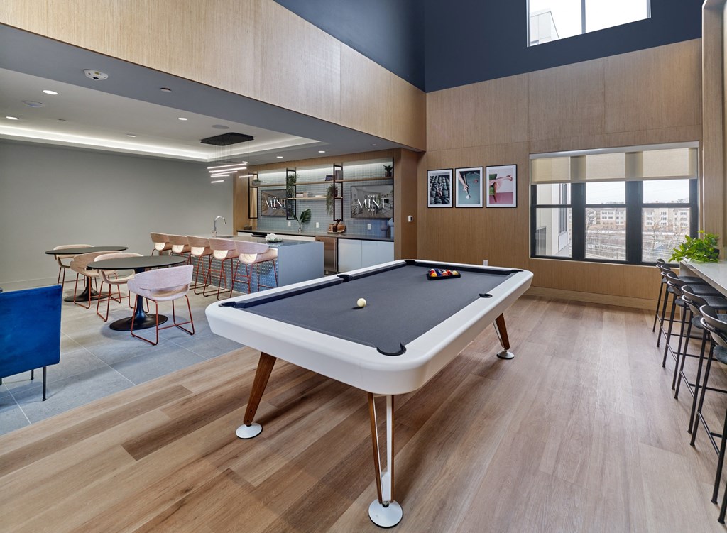 a billiards table in a break room with tables and chairs