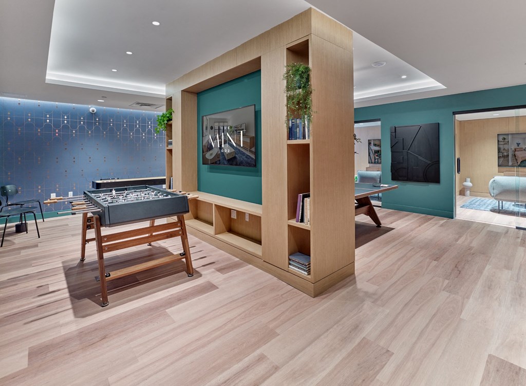 a reception area with a table and chairs and a blue wall
