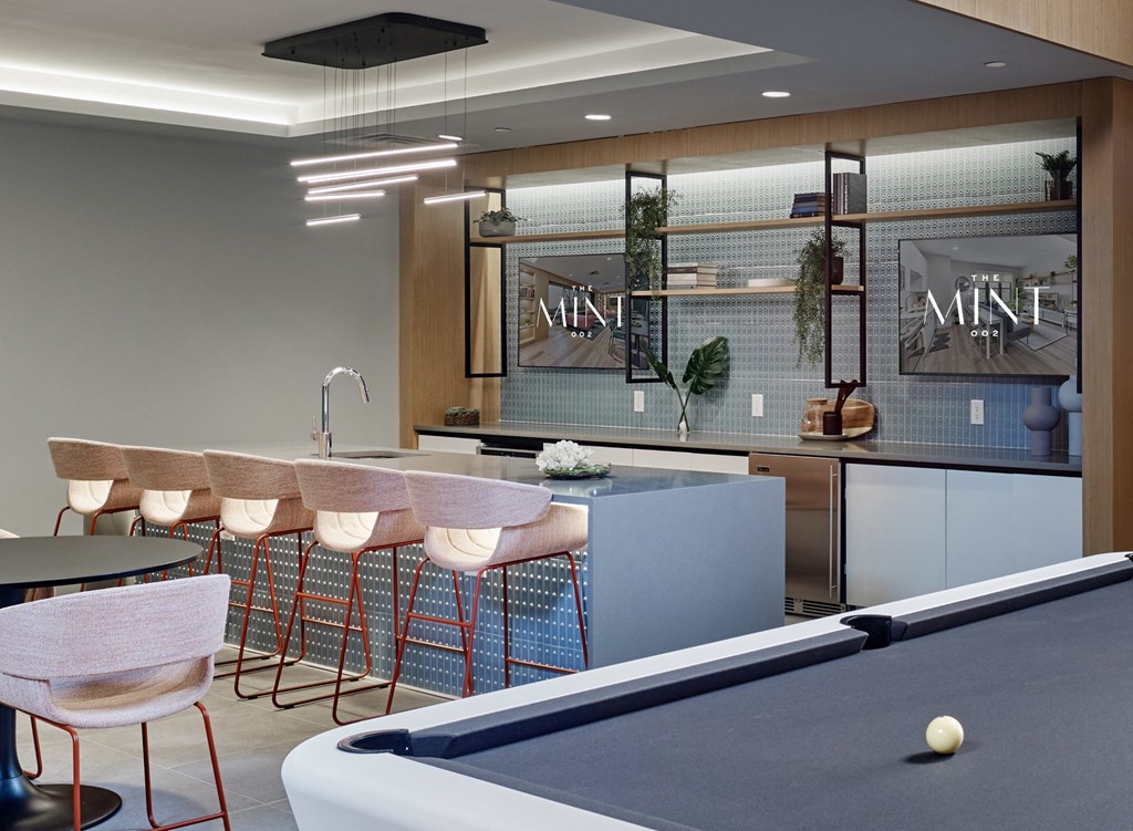 a communal area with a pool table and a bar