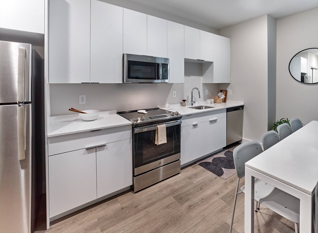 Fully equipped modern kitchen in a studio apartment at The Mint Rahway, perfect for those seeking luxury apartment rental with an open floor plan.