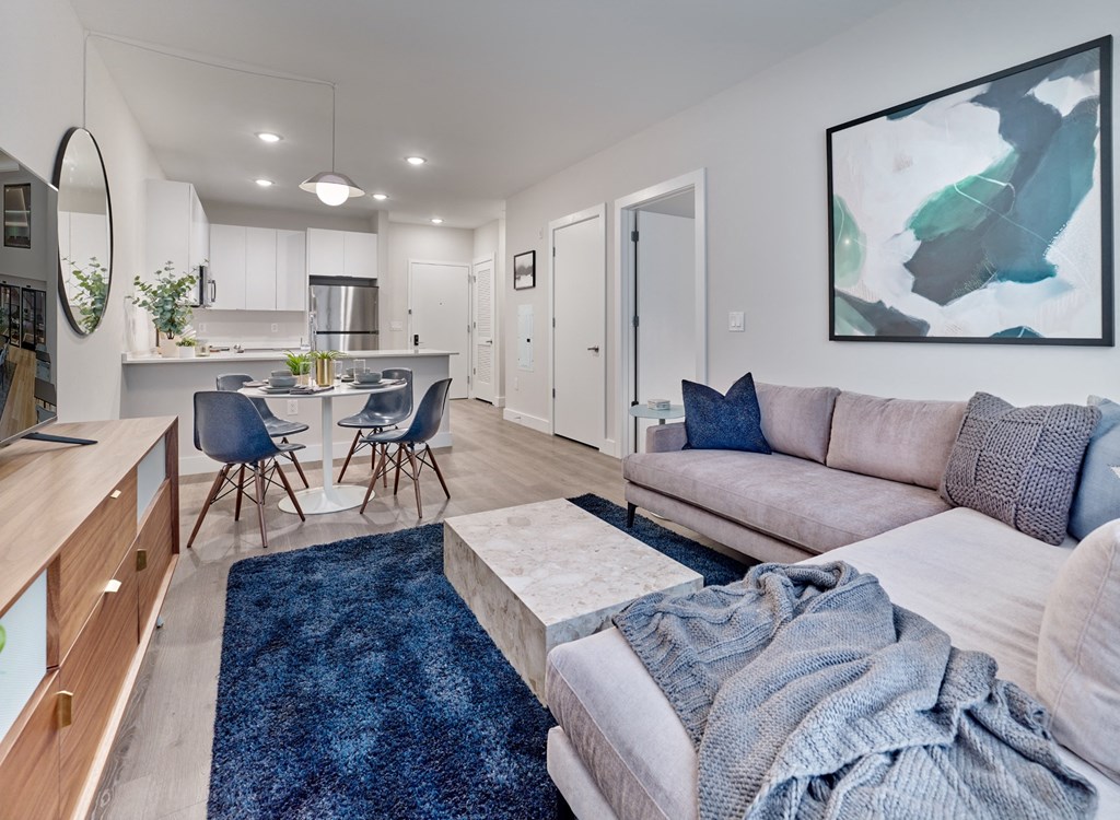 a living room with a couch and a table with chairs