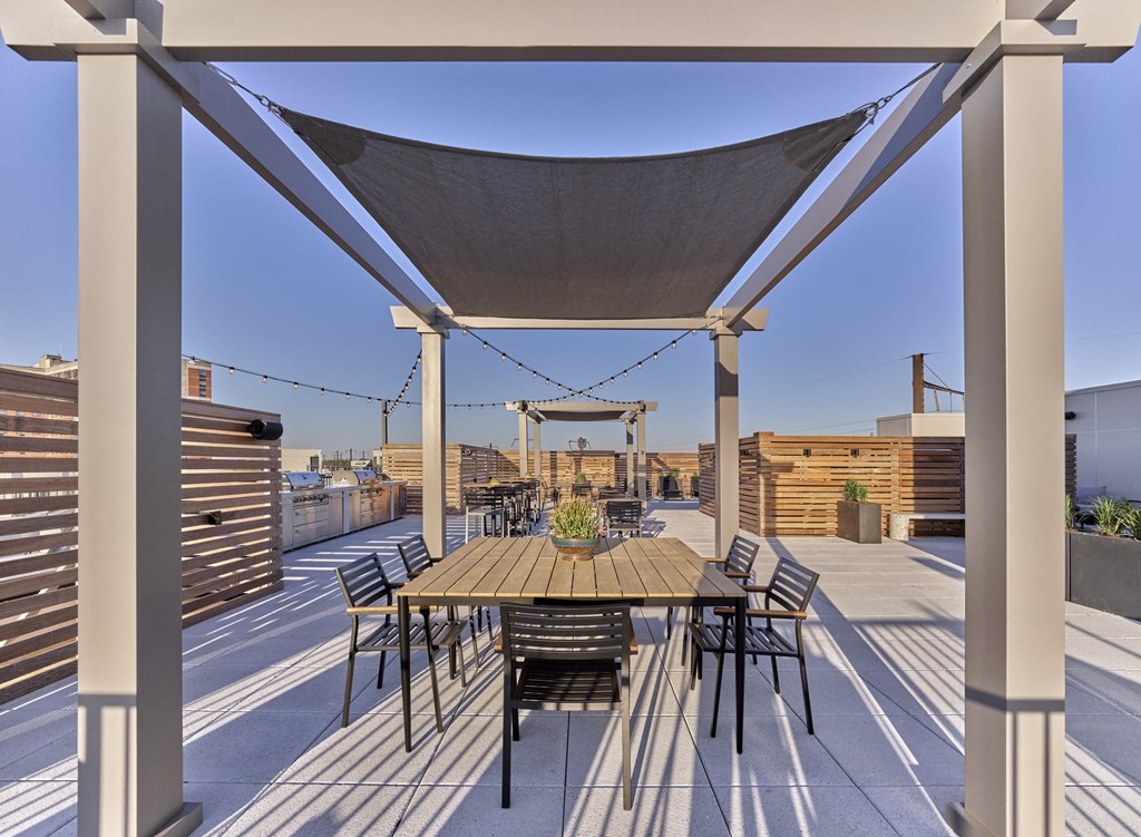 Rooftop terrace at The Mint Rahway with dining and lounging areas, offering stunning views, close to Rahway Train Station and Union County Performing Arts Center.