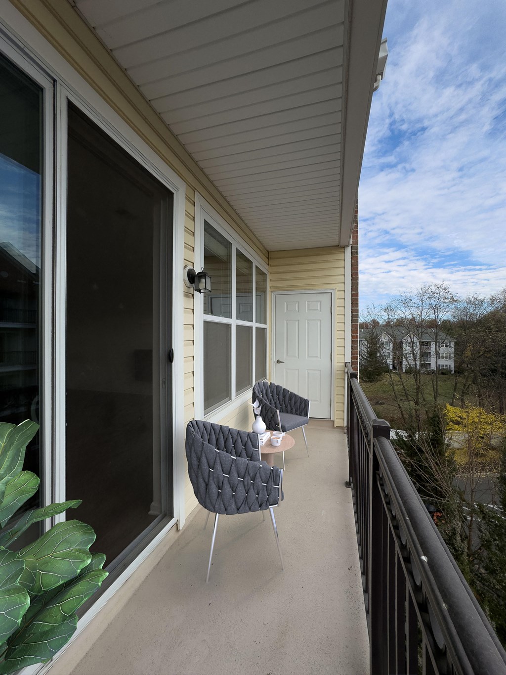 Modern apartment balcony at Queens Gate Apartments in Bound Brook, NJ with a spacious layout, featuring outdoor seating and scenic views. Ideal for relaxation and city living with an open-air feel.