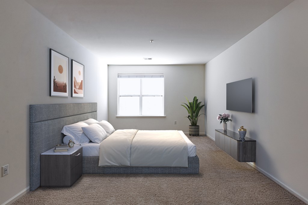 Modern bedroom with a minimalist layout at Queens Gate Apartments in Bound Brook, NJ, Featuring a large window that allows natural light to fill the space. Neutral tones and clean lines create a spacious and inviting atmosphere