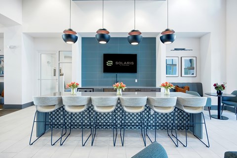 A modern dining area with a Solaris TV mounted on the wall.