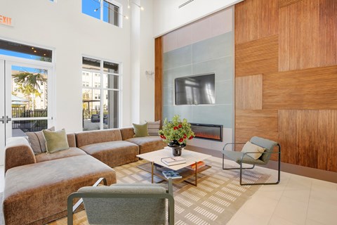 A living room with a brown couch and a coffee table.