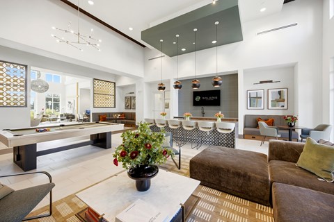 A living room with a pool table and a couch.