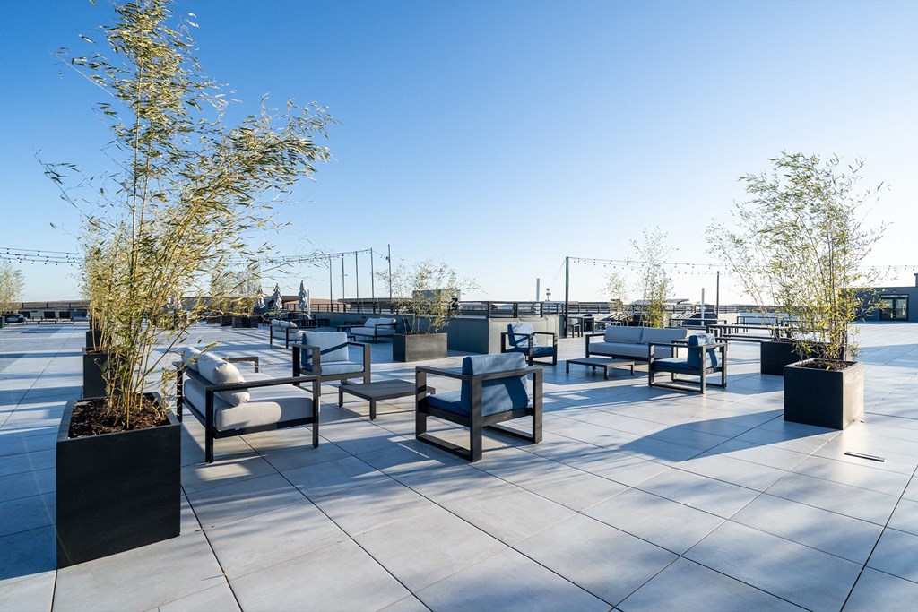 Rooftop seating area with tables and chairs at The Botanic, Carteret, NJ, 07008