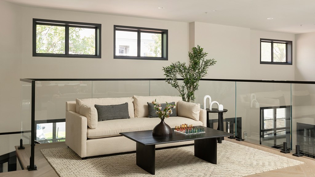 Stylish resident lounge at The Mews at Princeton Junction featuring comfortable seating and a bright, airy layout for relaxation and community gatherings.