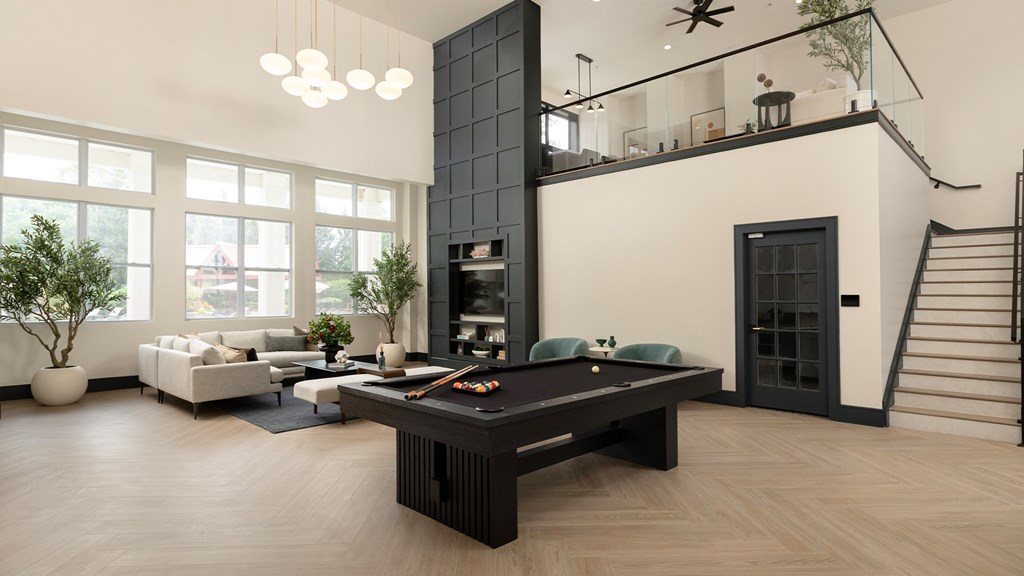 Designer lounge with a black marble fireplace and custom shelving at The Mews at Princeton Junction, offering luxurious condo-style living in Princeton NJ.