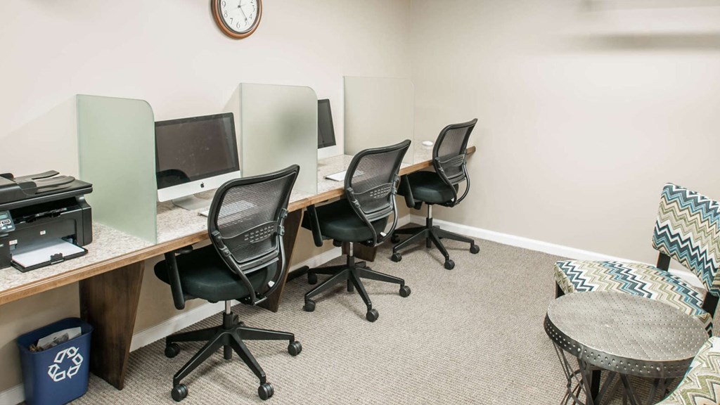 Resident business center with iMac workstations at The Pepper Building apartment complex in Philadelphia, located at 1830 Lombard Street near Rittenhouse Square.