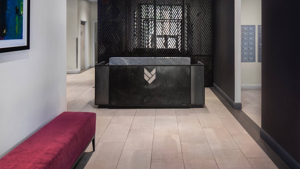 A black reception desk with a logo on it.
