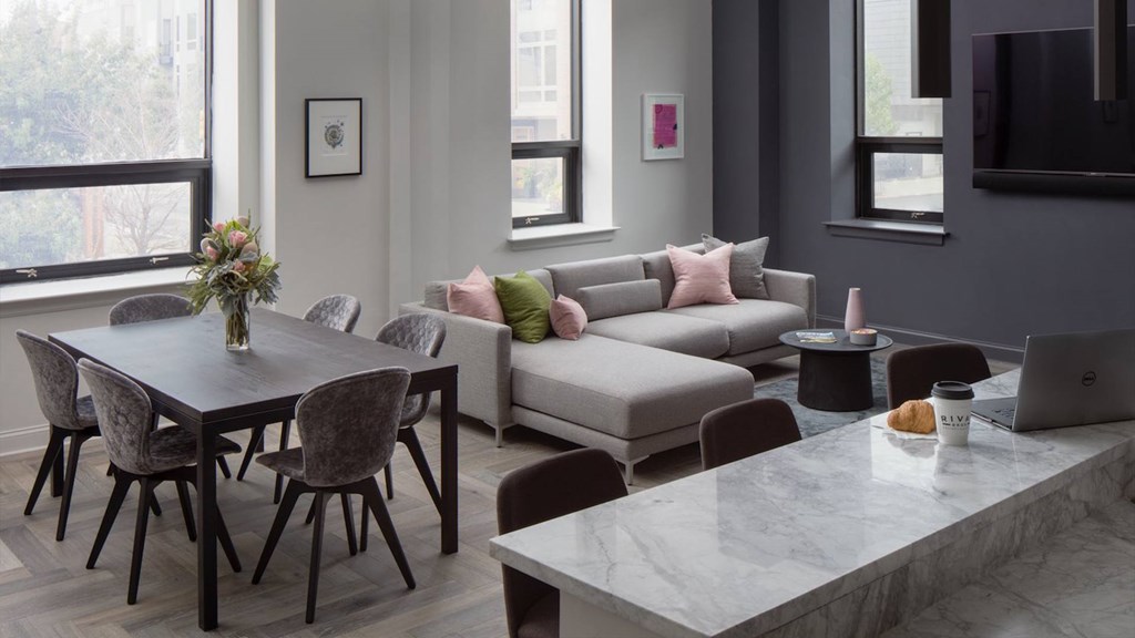 Open-concept living and dining area in a Rittenhouse apartment at The Pepper Building, featuring upscale finishes and natural light.