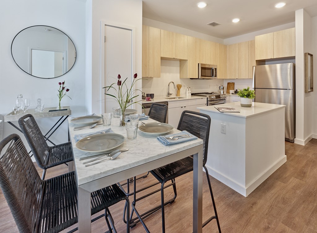 a kitchen and dining room with a table and chairs