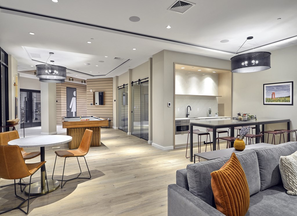 a living room and kitchen with a couch and tables