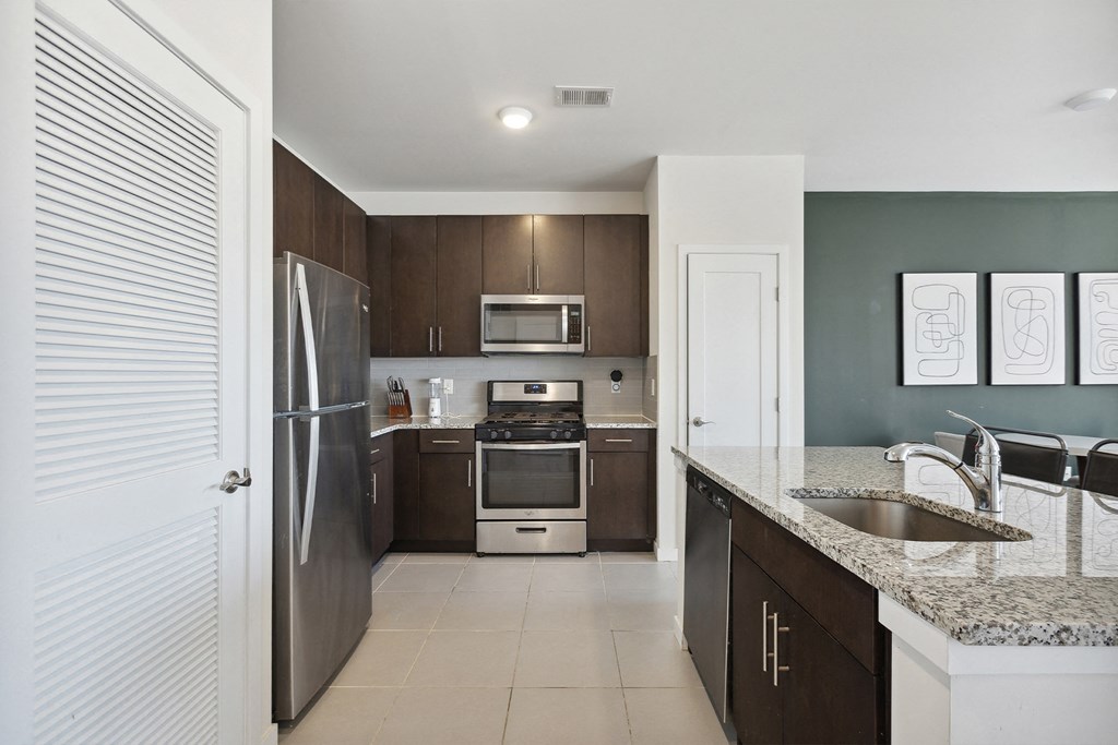 Modern kitchen with stainless steel appliances at The Lofts at Middlesex