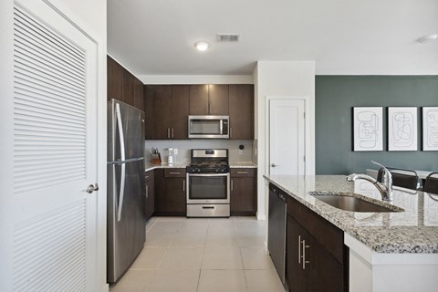 a modern kitchen with stainless steel appliances and granite counter tops