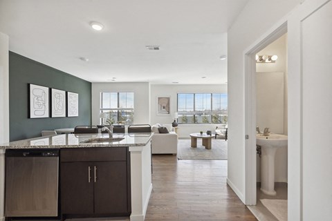 an open kitchen and living room with a sink and a table