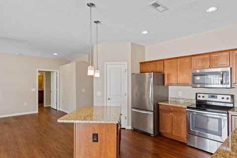 A kitchen with wooden cabinets and a granite countertop in Florence, KY