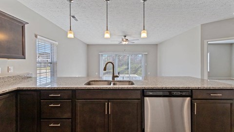 Modern kitchen with stainless steel appliances at The Villages of Florence and Weaver Mill