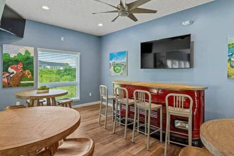 Clubhouse with a bar and TV at The Villages of Florence and Weaver Mill