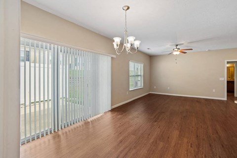 A room with wooden floors and a ceiling fan at The Villages of Florence and Weaver Mill
