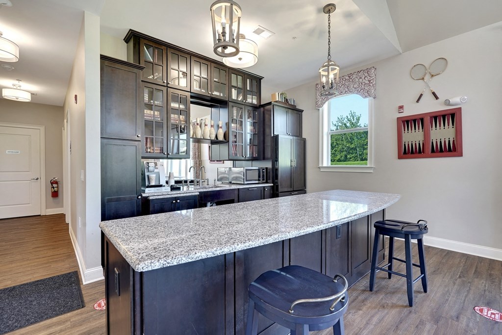 a kitchen with a granite counter top and bar stools