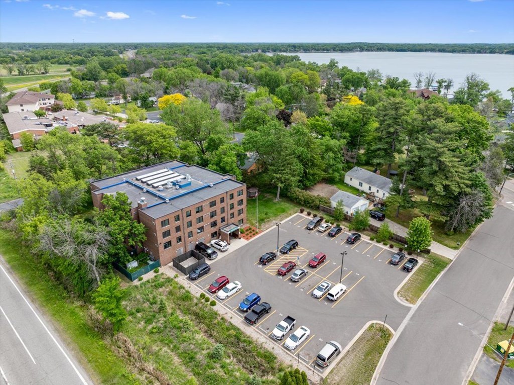 A parking lot with cars and a building in the background.