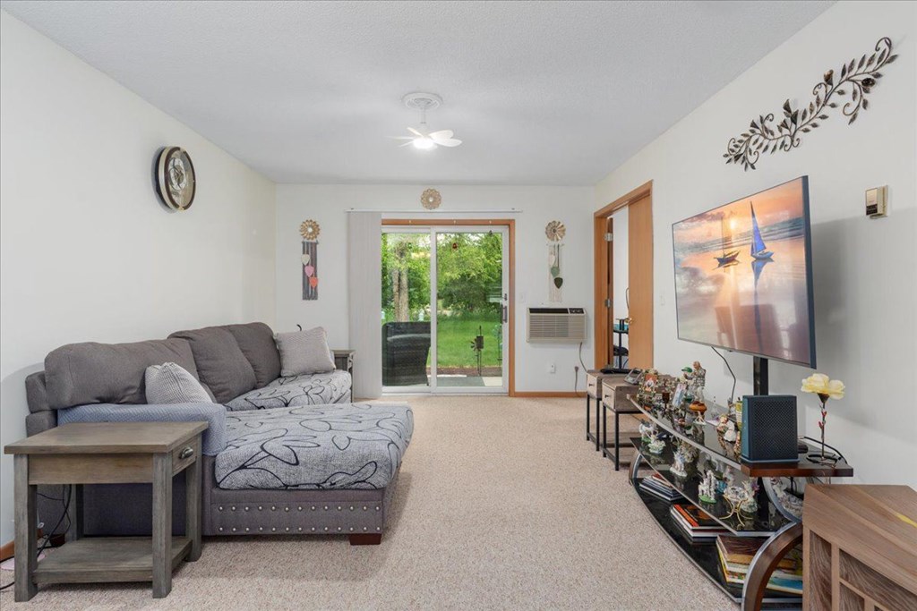 A living room with a grey couch and a television.