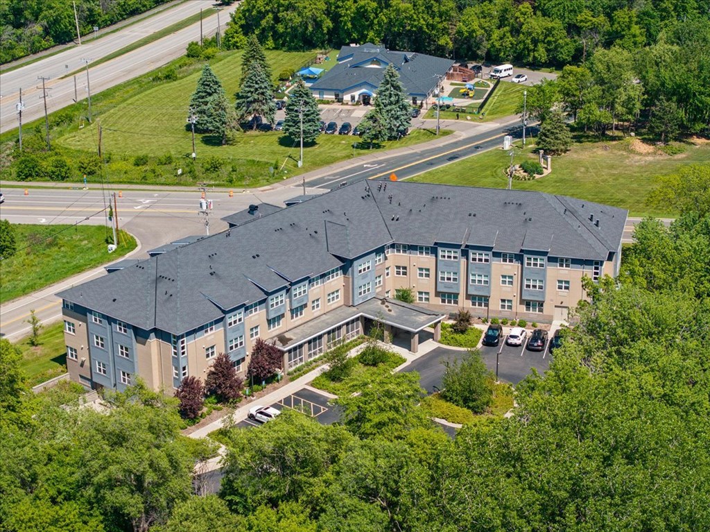 A large building with a parking lot in front of it.