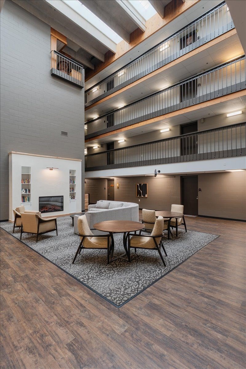 A modern living room with a fireplace and a dining table.