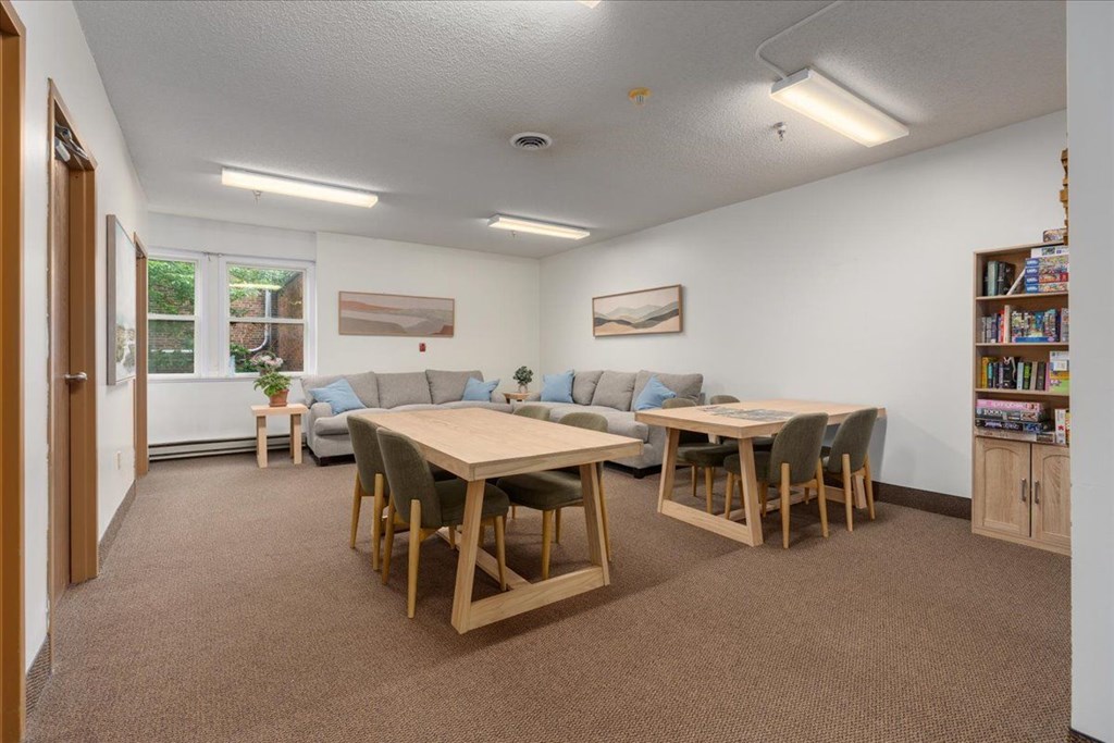 A room with a table and chairs in it.