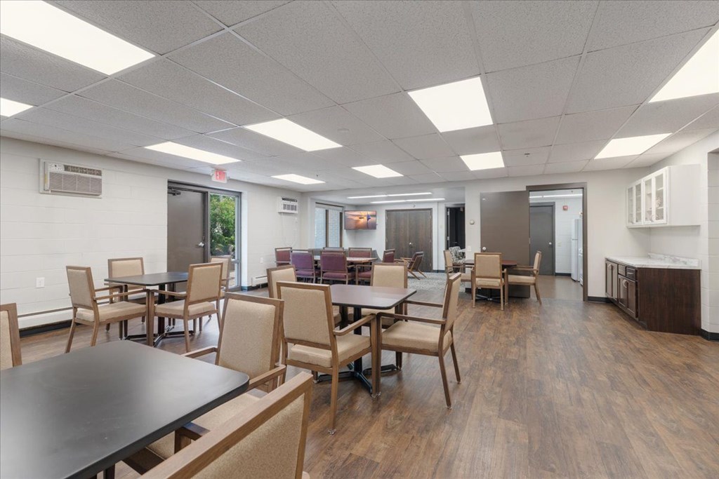 A conference room with a long table and chairs.